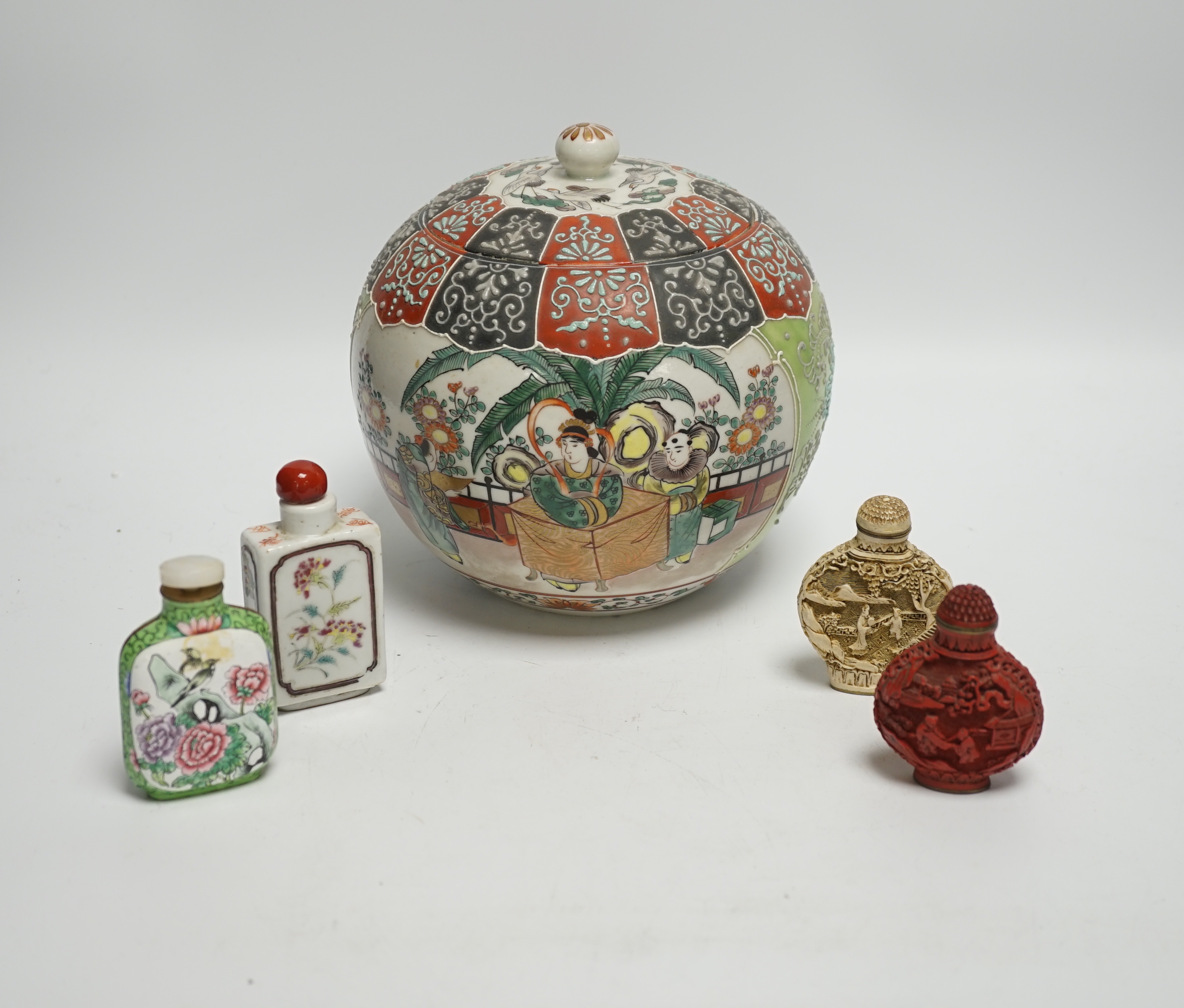 An early 20th century Japanese famille rose snuff bottle together with three others and a lidded jar